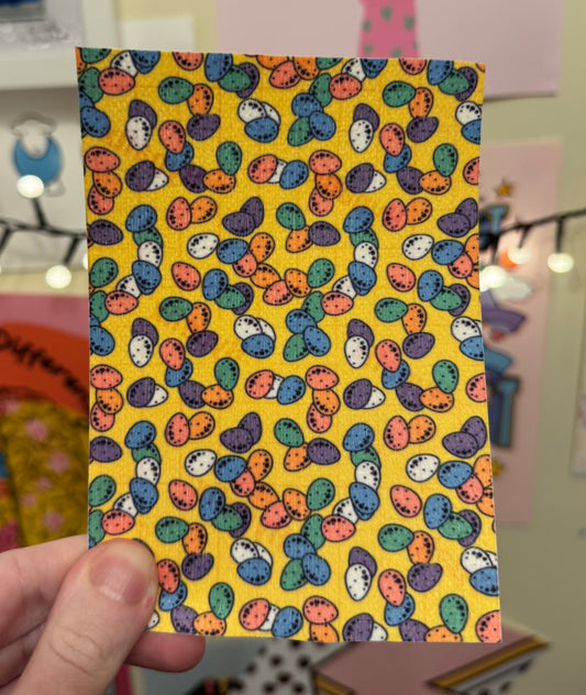 Mini eggs chocolate on yellow Easter collection tubie tape