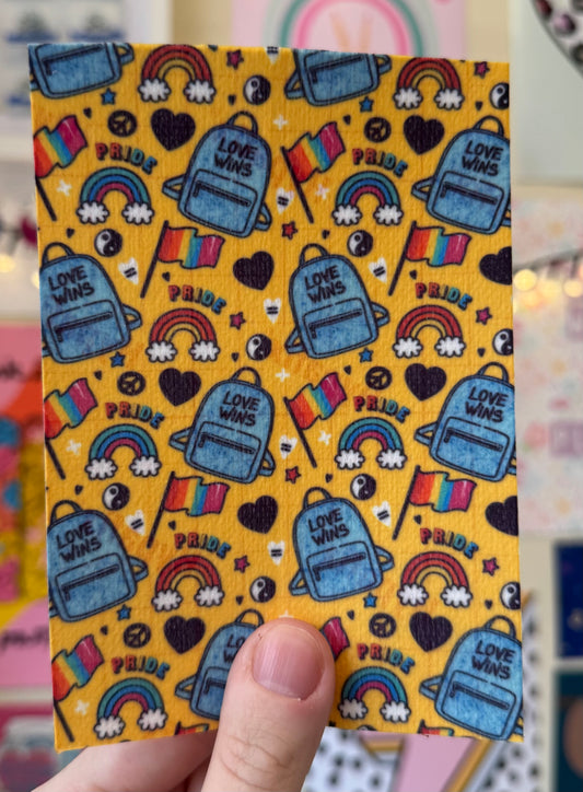 Love wins bags, pride flags on yellow LGBT pride 2025 Tubie tape
