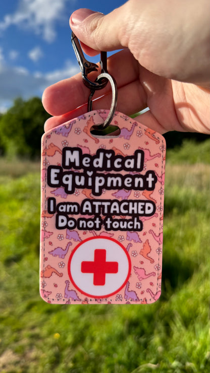 Medical bag tag “medical equipment, I am attached, do not touch” (pink Dino print)